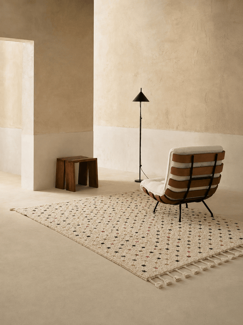Handmade Moroccan Berber wool rug with colorful geometric patterns in a minimalist room